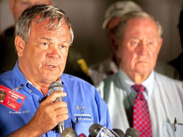 Mike Houghton, president of the Reno Air Racing Association (L) holds a news conference after a vintage World War II-era fighter plane plunged into the grandstands during a popular annual air show.