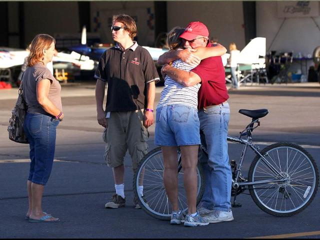 Bystanders embrace after a Second World War fighter plane crashed into the stands at the Reno Air Races in Stead, Nevada.
