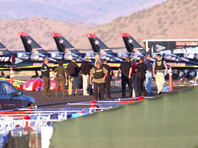 People gather at the scene where a Second World War fighter plane crashed into the stands at the Reno Air Races in Stead, Nevada.