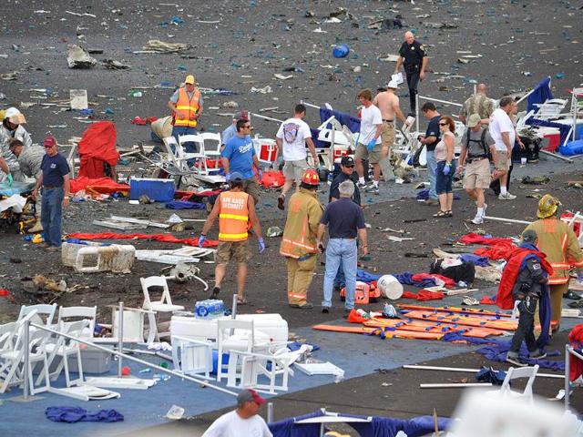 A crowd gathers around debris after a P-51 Mustang airplane crased at the Reno Air show in Reno Nevada. The plane plunged into the stands at the event in what an official described as a "mass casualty situation."