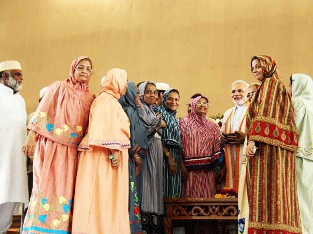 Women from the minorities come to greet Narendra Modi at the fast venue.