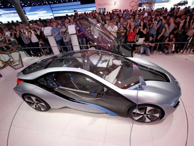 Visitors view the BMW i8 concept car at the 64th International Motor Show (IAA) in Frankfurt. The world's biggest auto show is open to the public and runs until September 25.