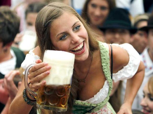 A young woman poses with a beer mug in the Hofbraeuhaus-tent after the opening of the famous Bavarian Oktoberfest festival in a tent in Munich, southern Germany.