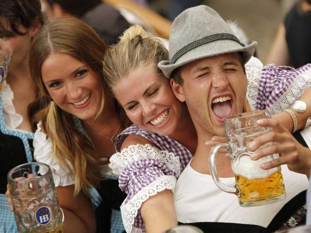 Young people lift up their beer steins after the official opening of the famous Bavarian Oktoberfest festival in Munich, southern Germany.