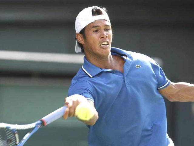 Somdev Devvarman returns the ball against Yuichi Sugita of Japan during their Davis Cup World Group playoff in Tokyo.