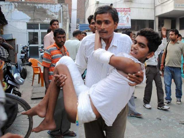 An injured man is taken to the hospital after a blast in Agra.