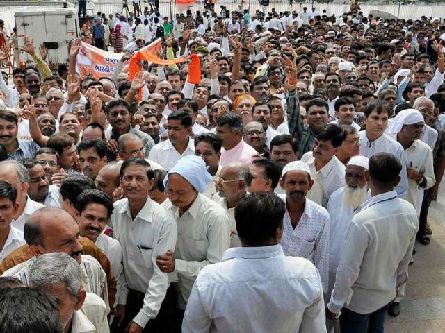 Supporters rush to the hall to meet Gujarat's chief minister Narendra Modi, sitting on the second day of his fast in Ahmedabad.