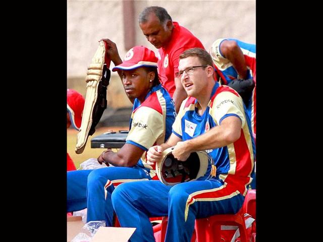 Royal Challengers Bangalore skipper Daniel Vettori with Chris Gayle during a practice session for Champions League 2011 at National Cricket Academy ground in Bangalore.