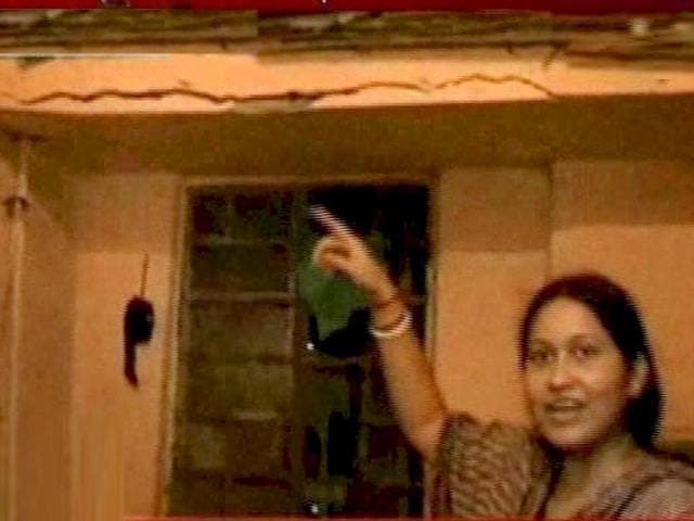 **TV GRAB** A lady shows crack in her wall, after an earthquake occurred in Kolkata. An earthquake of intensity measuring 6.8 on Richter Scale with its epicenter on the Sikkim-Nepal border shook northeast and northern parts of the country, including the national capital.