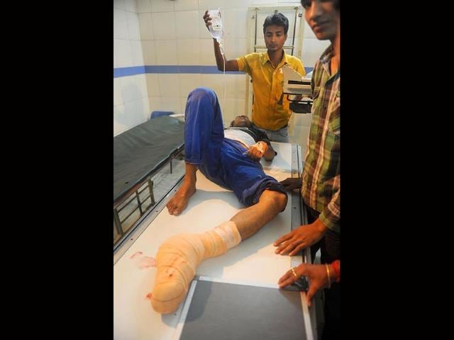 An injured man lies on a medical gurney in a hospital in Siliguri after an earthquake hit Sikkim.