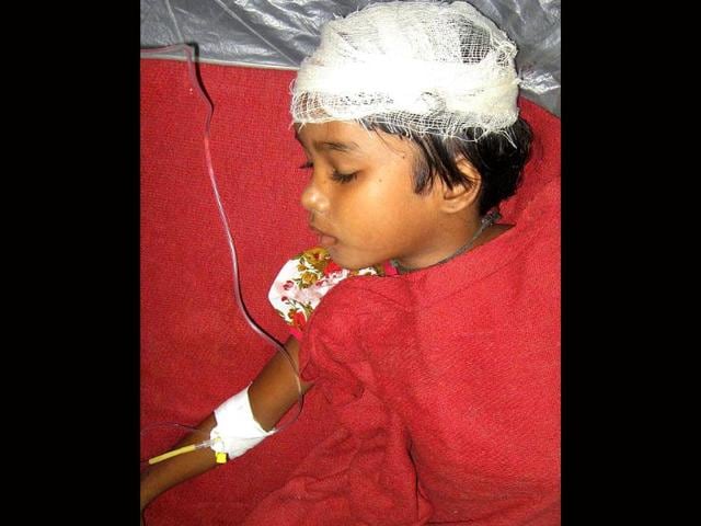 A child who was injured in a building collapse that followed an earthquake is treated at a hospital in Siliguri.