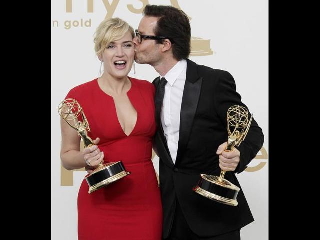 Mildred Pierce cast members Kate Winslet, left and Guy Pearce hold the Emmys for best actress and best supporting actor in a miniseries. (AP)