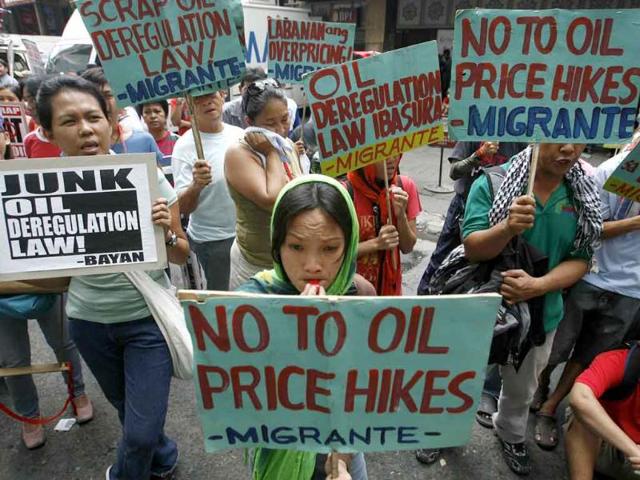 Supporters of a transport strike hold signs as they rally along a road in Quezon City, Metro Manila.