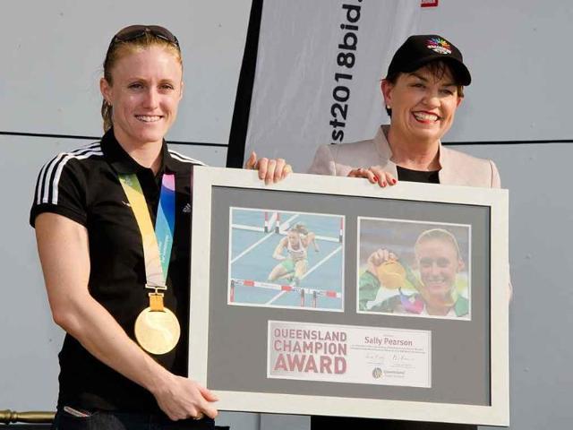 Queensland state Premier Anna Bligh (R) poses with 100 metres hurdles world champion Sally Pearson (L) during a welcome home ceremony in Gold Coast City.