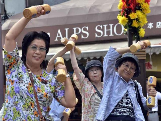 Elderly people work out with wooden dumb-bells in the grounds of a temple in Tokyo to celebrate Japan's Respect-for-the-Aged-Day.