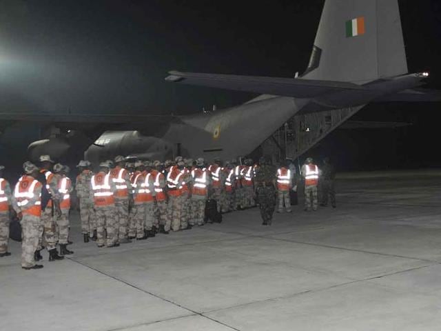 Indian Air Force (IAF) personnel load supplies onto a C-130J aircraft at an airbase in New Delhi, as part of emergency airlift of rescue equipment and supplies to the north-eastern Indian state of Sikkim following an earthquake.
