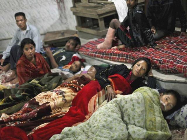 Residents and patients from a local hospital take shelter in a temple after Sunday's earthquake in Gangtok.