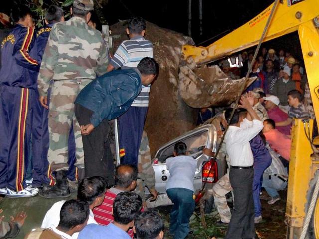 Army rescue team pull out a vehicle crushed by a boulder after Sunday's earthquake at Chungthang in north Sikkim.