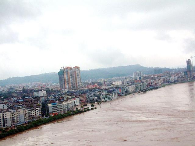 The swelling river rises in Guangan city, southwest China's Sichuan province, as unprecedented rains over the past week have swamped parts of northern, central and southwest China.