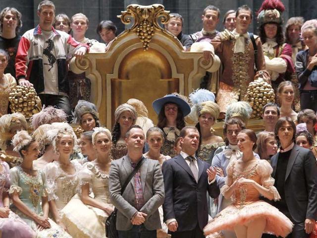 Russia's President Dmitry Medvedev (first row 5th R) talks to members of the company at the Bolshoi Theatre in Moscow.