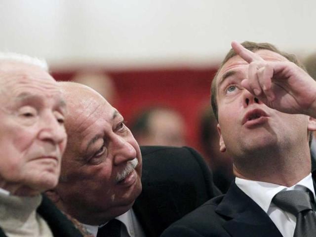 Russia's President Dmitry Medvedev (R), accompanied by the theatre director Anatoly Iksanov (C) and famous choreographer Yury Grigorovich, visits the Bolshoi Theatre.
