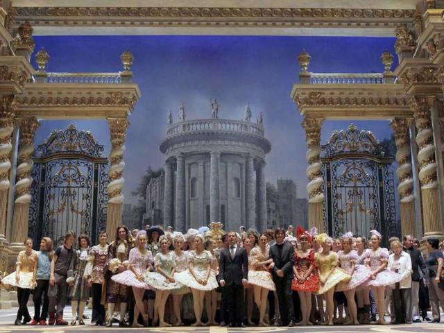 Russia's President Dmitry Medvedev (C) poses for a picture with members of the company at the Bolshoi Theatre.