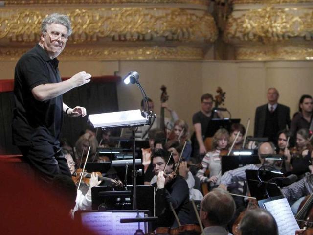 Conductor Vassily Sinaisky (L) and orchestra musicians rehearse The Sleeping Beauty ballet as Russia's President Dmitry Medvedev visits the Bolshoi Theatre.