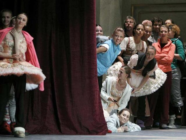 Ballet dancers watch Russia's President Dmitry Medvedev at the Bolshoi Theatre.
