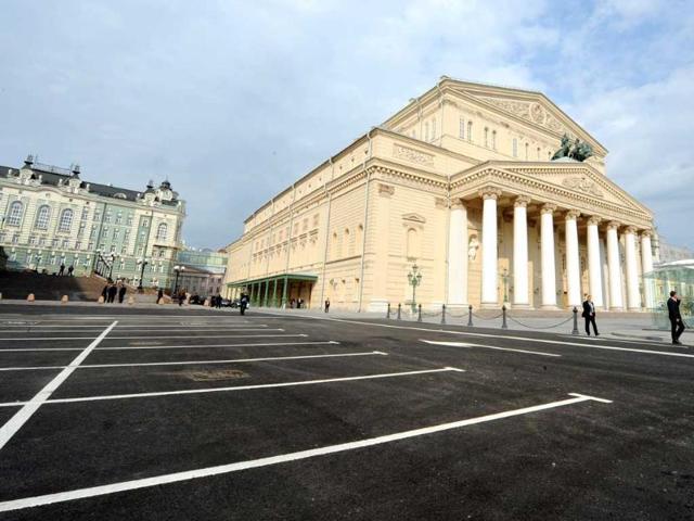 People walk past the Bolshoi Theatre in Moscow. Russian President Dmitry Medvedev visited the restored theatre, a landmark of Moscow built in the 1820s, closed in 2005.