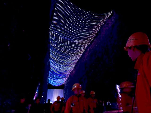 Guide miners stand during the opening ceremony of the new atraction, the largest LED node matrix in the world, inside the Salt Cathedral of Zipaquira.