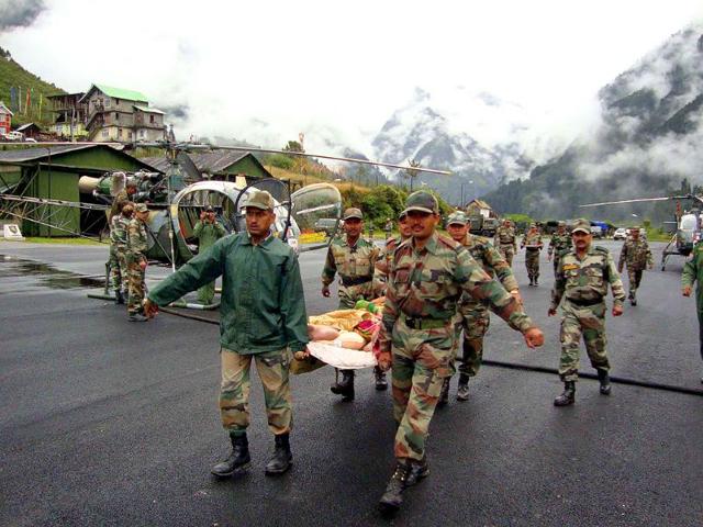 Army personel rescue injured jawans at Mangan in north Sikkim.
