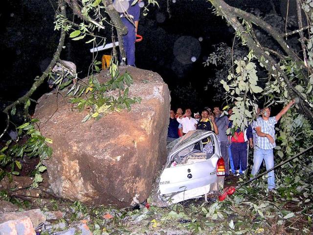 Army rescue team tries to pull out a vehicle crushed by a boulder during Sunday's earthquake at Chungthang in north Sikkim.