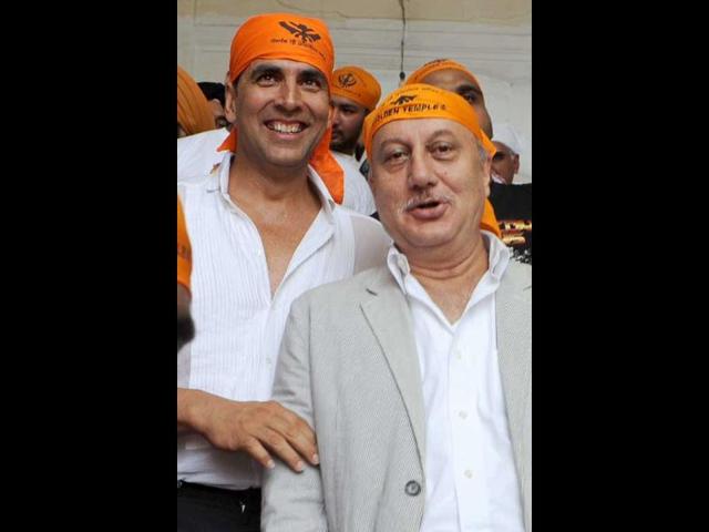 Akshay and Anupam pose together.