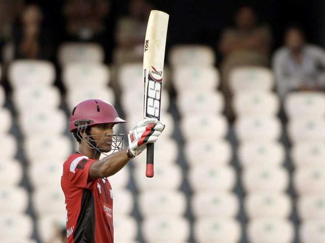 Ruhuna’s cricket player Dinesh Chandimal raises his bat to celebrate scoring fifty runs during the Champion League Twenty20 qualifying cricket match between Ruhuna and Leicestershire in Hyderabad.