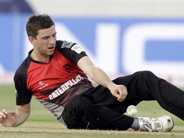 Leicestershire bowler Harry Gurney tries to stop the ball during the Champion League Twenty20 qualifying match between Ruhunu Eleven and Leicestershire in Hyderabad.