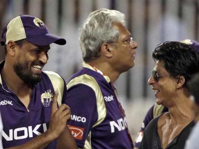 Bollywood actor and Kolkata Knight Riders team owner Shah Rukh Khan, right, gestures to Yusuf Pathan, left, during the Champions League Twenty20 qualifying cricket match between Kolkata Knight Riders and Somerset in Hyderabad.