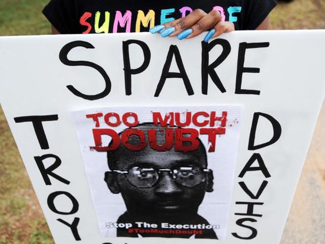 Brittany Stokes of McDonough holds a sign calling for Georgia state officials to halt the scheduled execution of convicted cop killer Troy Davis at the Georgia Diagnostic and Classification Prison in Jackson.