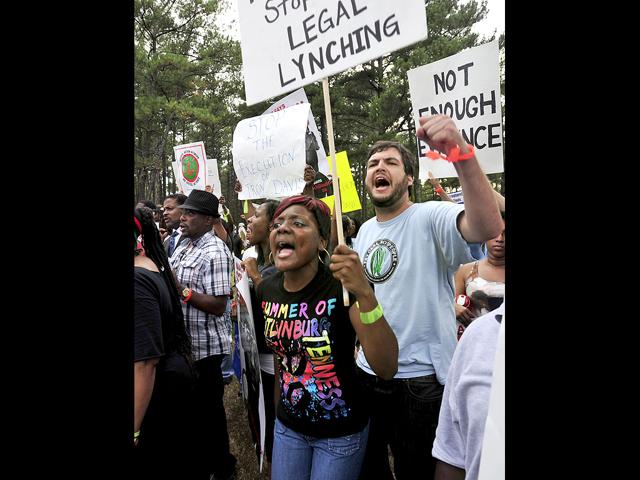 Protesters chant anti-death penalty slogans for Georgia death row inmate Troy Davis In Jackson, Ga., Wednesday, Sept. 21, 2011. Davis is scheduled to die Wednesday for killing off-duty Savannah officer Mark MacPhail.
