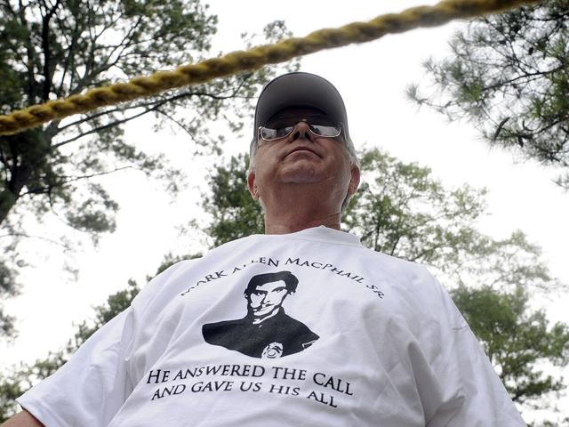 James McMenamin, wearing a T-shirt in support of murdered police officer Mark MacPhail, stands in a separate protest area at the Georgia Diagnostic and Classification prison where convicted killer Troy Davis is set to be executed by lethal injection in Jackson, Georgia September 21, 2011.