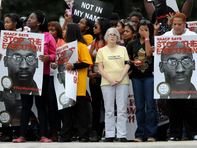 Demonstrators wait as they call for Georgia state officials to halt the scheduled execution of convicted cop killer Troy Davis at the Georgia Diagnostic and Classification Prison in Jackson, Georgia.