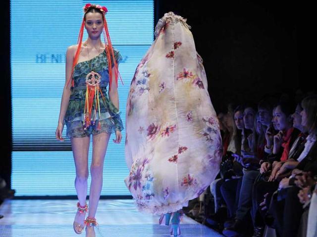 Models present creations by fashion designer Benito Fernandez during Trendation fashion week in Buenos Aires.