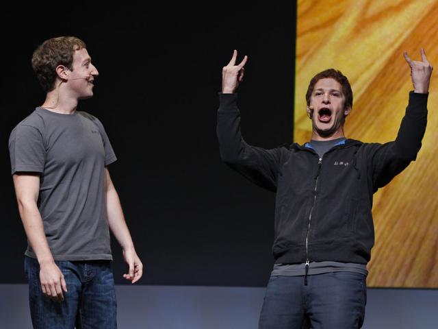 Facebook CEO Mark Zuckerberg, left, watches comedian Adam Samberg, right, of Saturday Night Live, gesture during the f/8 conference in San Francisco, Thursday, Sept. 22, 2011.