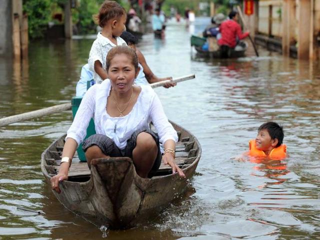 Cambodians use boats to navigate flooded streets at Kian Svay district in Kandal province, 20 kilometers east of Phnom Penh.