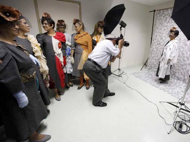 Cancer patient Nilsa Salles (R) poses for a photographer in front of her friends before the Festival of the Life fashion show at the Cancer Perola Byington Hospital in Sao Paulo.