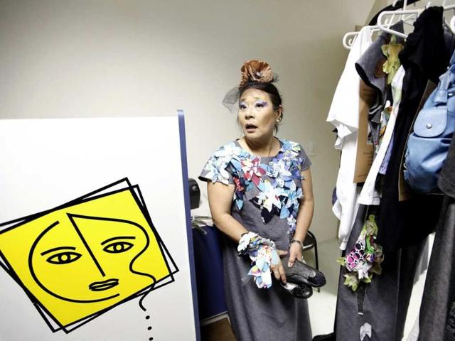 A cancer patient holds her shoes backstage for the Festival of the Life fashion show at the Cancer Perola Byington Hospital in Sao Paulo.
