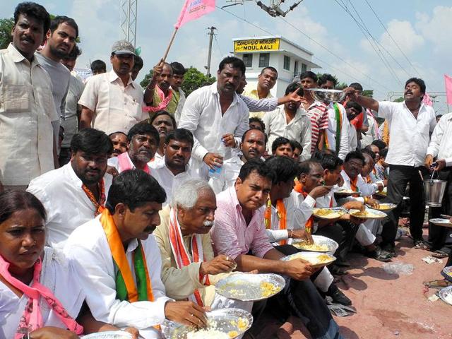 Protesters have lunch during 'Rail roko' call given by Telangana Joint Action Committee at Maula Ali Railway Station near Hyderabad in which TRS, New Democracy and BJP workers participated along with families.
