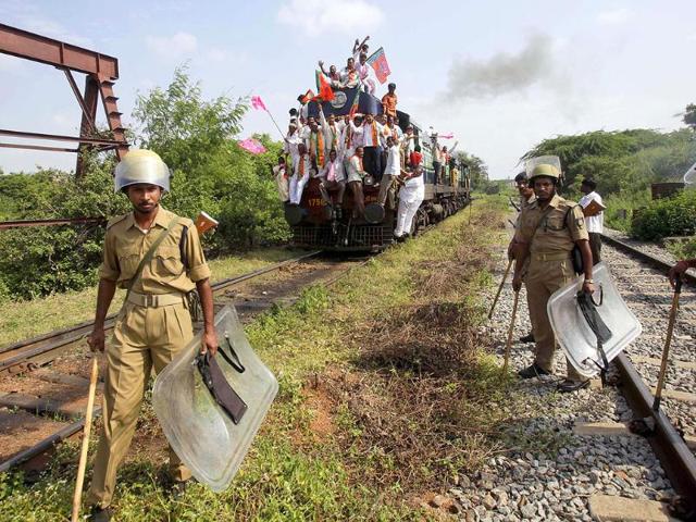 Security personnel gather near a train after supporters blocked it during a 48-hour railway strike, demanding the creation of the state of Telangana, in Hyderabad.