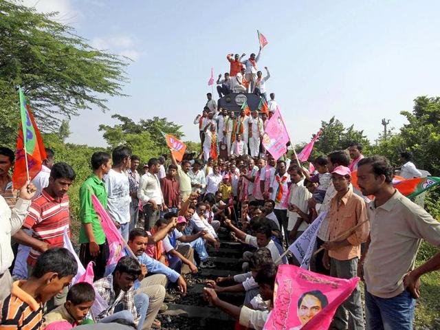 Supporters shout slogans after blocking a train during a 48-hour railway strike demanding the creation of Telangana, in Hyderabad.