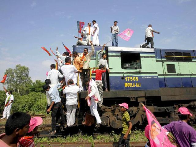 Supporters shout slogans after blocking a train during a 48-hour railway strike, demanding the creation of the state of Telangana, carved out from Andhra Pradesh, in Hyderabad.
