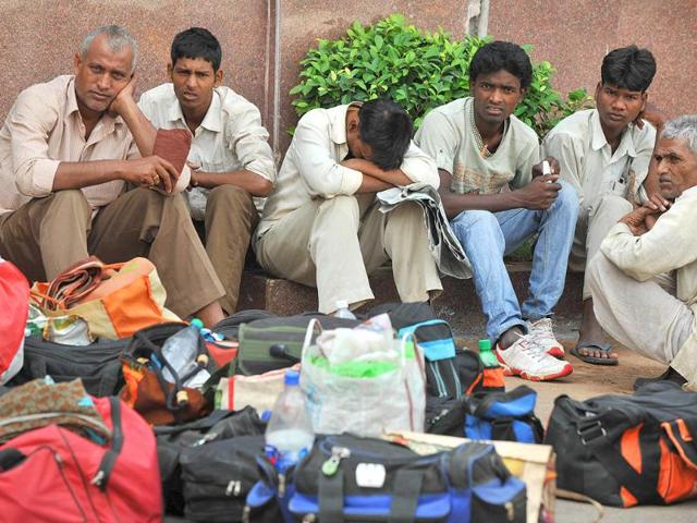 Stranded passengers wait outside a station during a 48-hour railway strike in the Telangana region in Hyderabad.